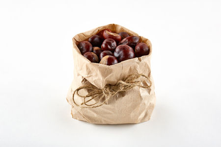 Chestnuts in paper bag on white background.の写真素材