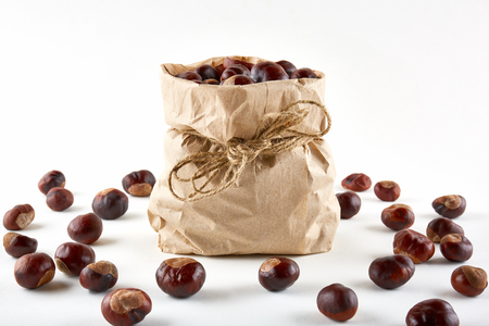 Chestnuts in paper bag on white background.の写真素材