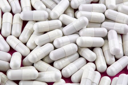 Close-up photo of many white capsules. Medicine.の写真素材