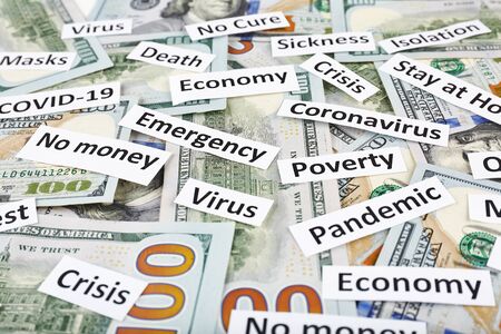 Coronavirus, COVID-19 headline clippings on 100 USD banknotes.