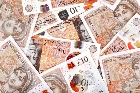 A lot of United Kingdome 10 pounds banknotes. Money horizontal background.
