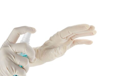 Hands in sterile rubber gloves with antiseptic spray isolated on white.