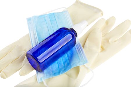 Antiseptic spray, blue medical face mask and sterile rubber gloves isolated on white background