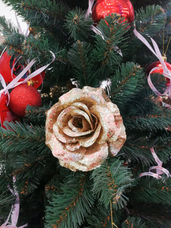 Golden flower on a Christmas green tree close upの写真素材