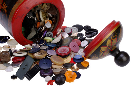 Multicolored buttons and spools of thread on light blue background - sewing concept
