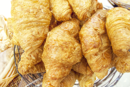 Croissants with poppy and sesame in a basketの写真素材