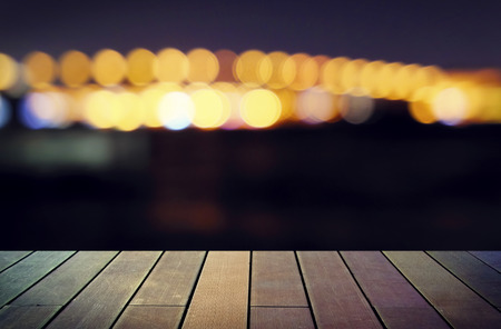image of wooden table in front of abstract blurred background