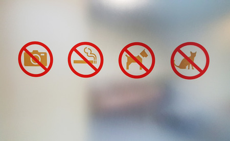 Prohibition signs on the glass and backgroundの写真素材