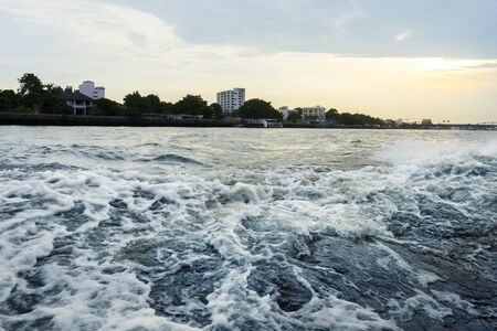 Water surface with ripples and sunlight reflectionsの写真素材