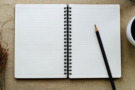 Black pencil on open white paper note bookの写真素材