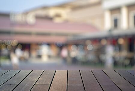 image of wooden table in front of abstract blurred background の写真素材