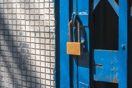 Close up old door locked with chain and padlock