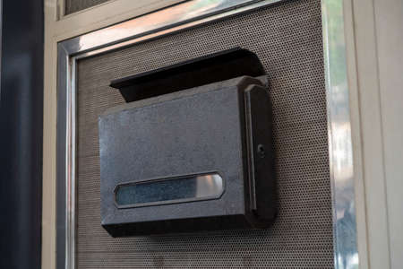 A mailbox and corrugated metal sheet,Slide door  home or office outside