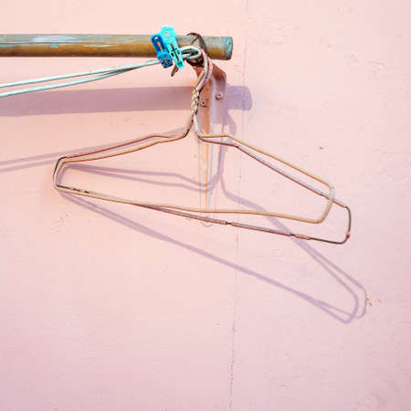 Clothes hangers and shadow of rack in the background