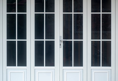Close up view of steel door handles on glass doors isolatedの写真素材