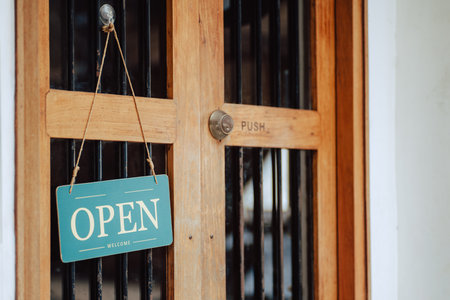 open sign hanging outside a restaurant, store, office or otherの写真素材