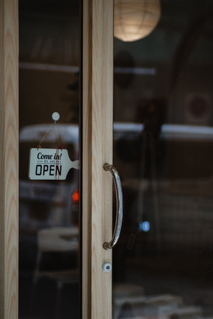 open sign hanging outside a restaurant, store, office or otherの写真素材