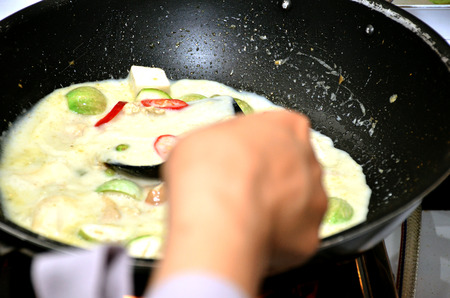 Thai food cooking, Green curry cooking in pan blackの写真素材