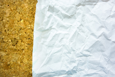 Wrinkled paper on cork board-use as backgroundの写真素材
