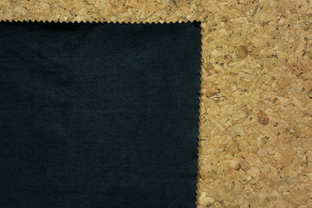 Black fabric with zig zag edge on cork board,backgroundの写真素材
