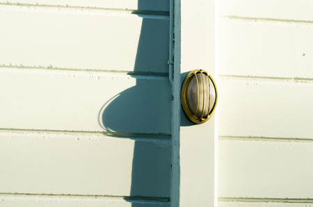 Wall lamp on pole at cement wall