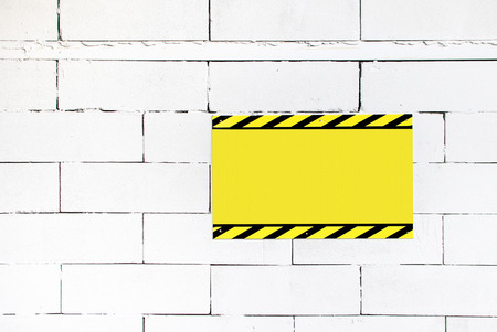 Cement block wall with blank warning poster,template to fill your textの写真素材