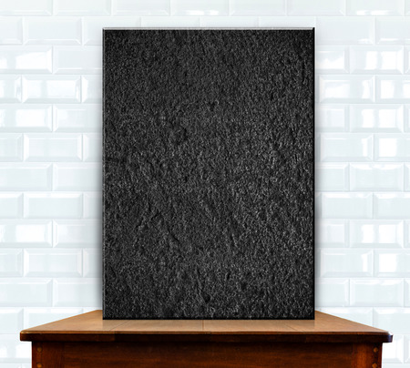 blank stone on wood table at white ceramic tiles wallの写真素材