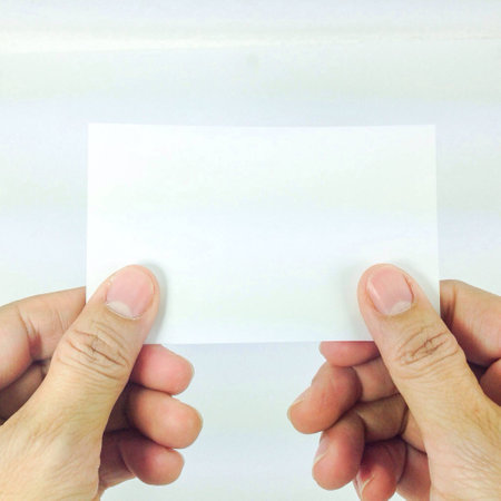 Hand holding blank business cardの素材