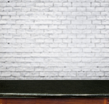 Empty black marble table and white brick wall in background. product display template.の写真素材