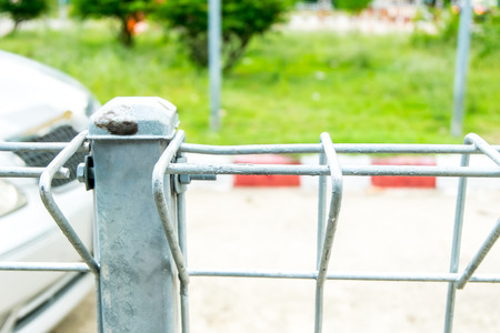 Wire fence at road and red line parking.の写真素材