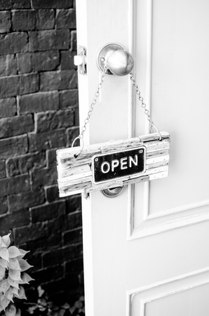 open label hanging on blue door in garden.の写真素材