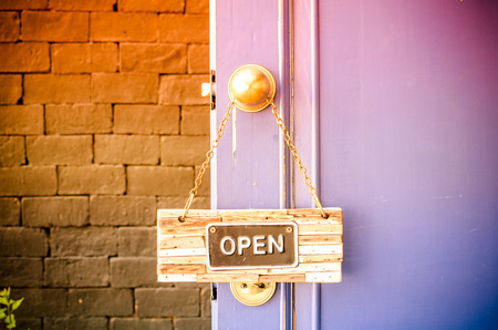 open label hanging on blue door in garden.の写真素材