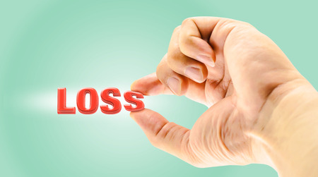 Man's Finger picking " Loss " word on light green background,Business concept,one of business factorの写真素材