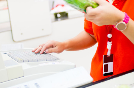 Counter cashier key price of farm product for customer at supermarket.の写真素材