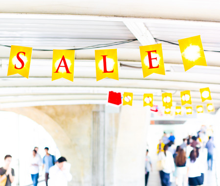 Yellow sale tag hanging on white pathway roof,promotion price.の写真素材