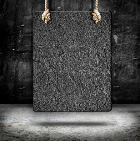 Hanging sand stone frame with rope at concrete wall and cement floor,Mock up for add your content,business presentation templateの写真素材