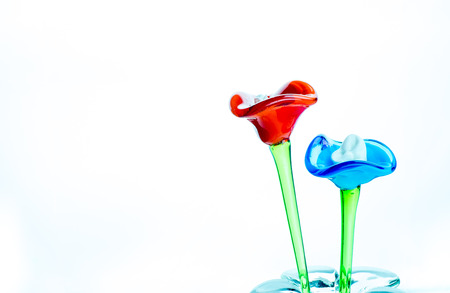 Flower made of glass in red and blue color in vase on white background,Template for add text.の写真素材