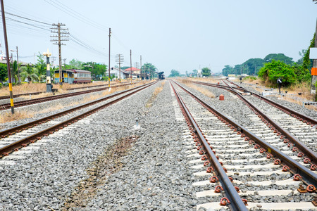 Vacant Rail way switch track with yellow die grass.