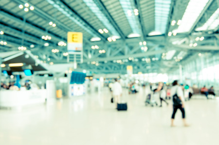 Blurred background : Traveler at airport terminal blur background with bokeh light,Vintage filter.の写真素材