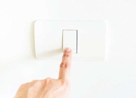 female Finger press on light button.