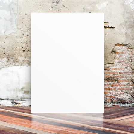White Blank Poster in crack cement wall and diagonal wooden floor roomの写真素材