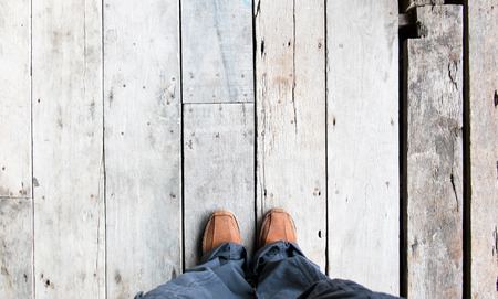 Leather shoe at an aerial view on wooden plank floorsの写真素材