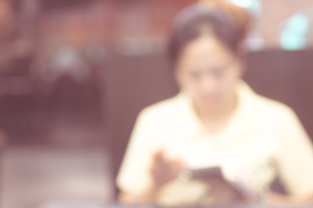 blur women play smart phone ,use for backgroundの写真素材