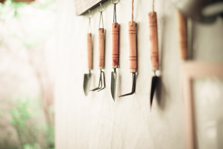 Garden tool hanging on concrete wall with wooden label.の写真素材