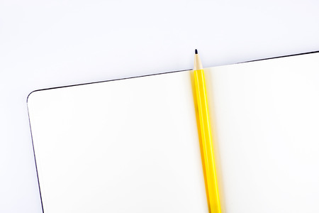 top view ofOpen notebook and yellow pencil with wish list topic on table,Template mock up for adding your content.の写真素材