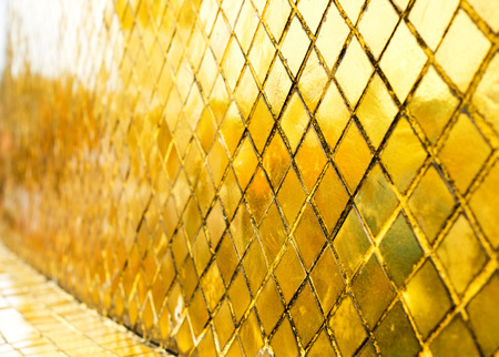 Glossy Gold mosaic tile wall, texture background in perspective.の写真素材