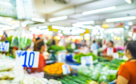 Blurred background  people shopping at market fair in sunny day, blur background with bokehの写真素材