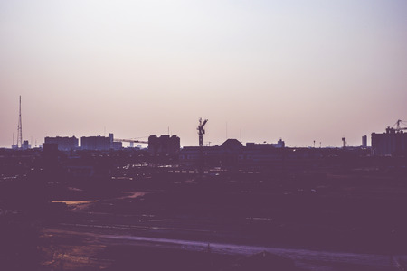 Vintage filter Silhouette of landscape sunset scene with city building.の写真素材