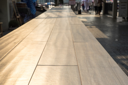 Perspective wood table top in front of shop at evening.の写真素材
