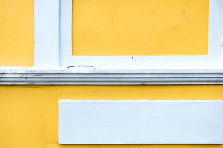 cracked yellow paint color concrete wall,texture background.の写真素材